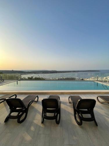 a group of chairs sitting on top of a building at Hotel VIU57 in Mellieħa