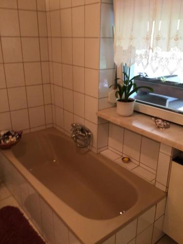 a bath tub in a bathroom with a sink at Ferienidylle Oberschützen in Oberschützen