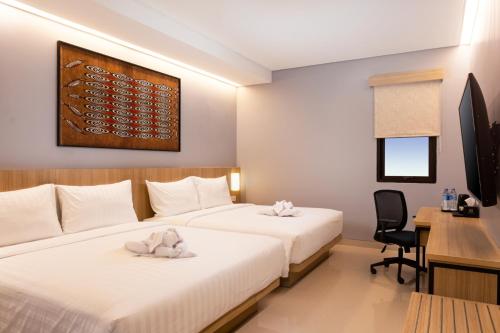 Voodi või voodid majutusasutuse BATIQA Hotel Jayapura toas