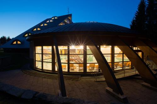 a building with a gazebo at night at Rezidence Klínovec in Loučná pod Klínovcem