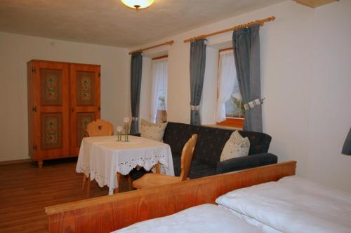 a living room with a couch and a table at Knotzenlehen in Ramsau