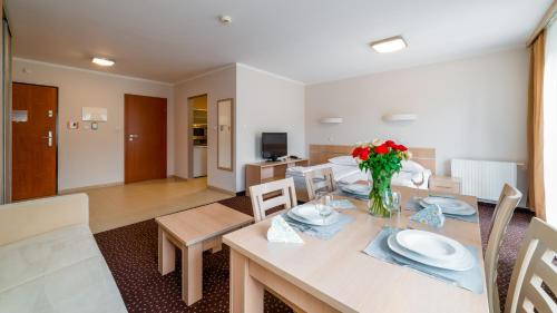 a dining room and living room with a table and chairs at Sofra, Sun & Snow in Karpacz