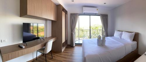 a bedroom with a large bed and a balcony at La habana Huahin in Hua Hin