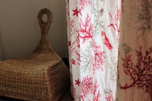 a vase sitting on a table next to a curtain at Hotel Villa Susy in Davoli