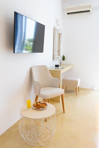 a living room with a chair and a table at Likio Studios in Batsi