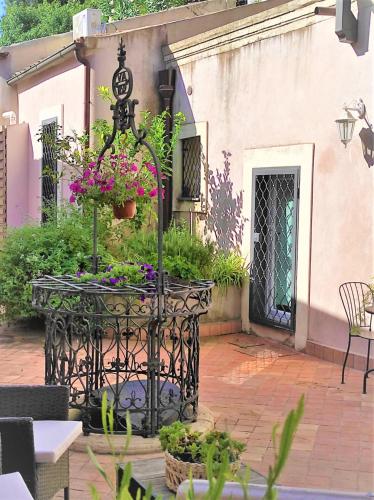 a table with flowers on it in front of a building at Frasteva Resort in Valverde