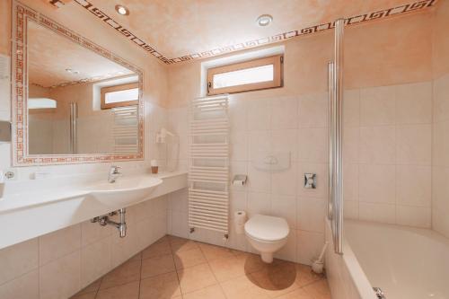 a bathroom with a sink and a toilet and a shower at Wellness Aparthotel Panorama Alpin - Ferienwohnungen Jerzens im Pitztal in Jerzens
