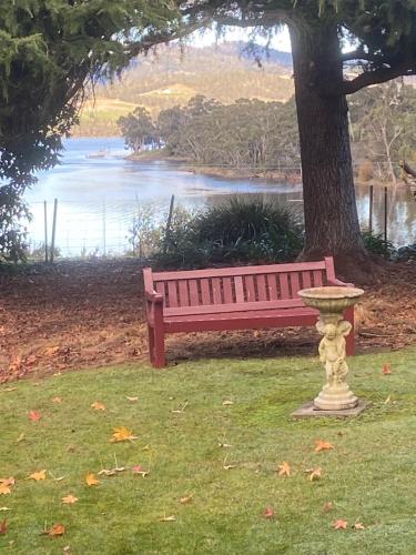 a bench sitting in the middle of a park at Donalea Bed and Breakfast & Riverview Apartment in Castle Forbes Bay