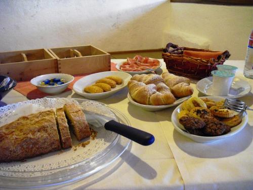 a table topped with plates of food on a table at Agriturismo La Lupa in Madonna della Provvidenza