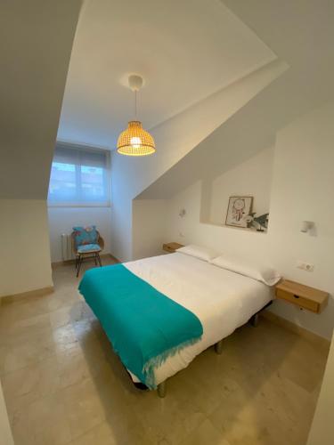 a bedroom with a large bed and a table at MARINA LLANES IV in Llanes