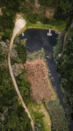 an aerial view of a lake with a boat in it at Thunzi Bush Lodge in Beachview