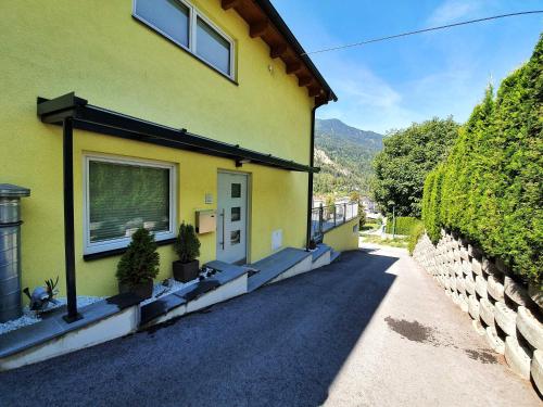 a yellow house with a window on the side of it at Apart Sunnseita in Prutz