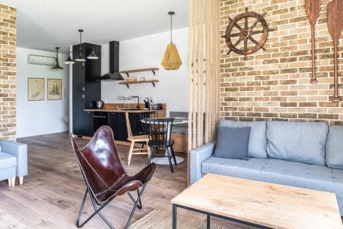 a living room with a couch and a brick wall at Nautica Resort in Giżycko