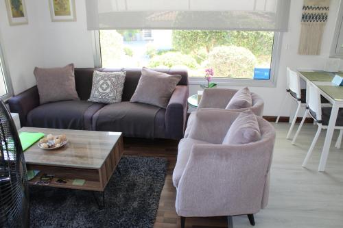 a living room with a couch and two chairs and a table at St.George's Country Retreat in Limassol