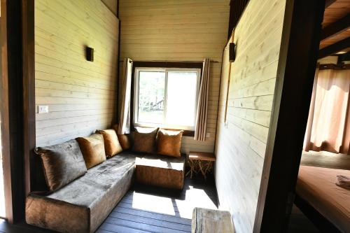 a couch in a room with a window at Tzlil Hateva in H̱osen