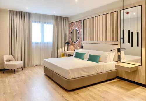 a bedroom with a large bed and a chair at Soho Boutique Córdoba in Córdoba