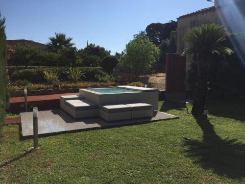 a garden with a pool in the grass at Bouganville B&B in Cefalù