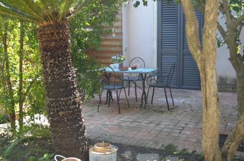 a table and chairs on a patio in a garden at Frasteva Resort in Valverde