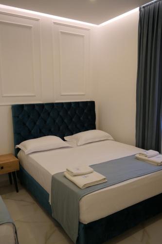 a bedroom with a bed with two towels on it at Apartments Oda Hotel in Velipojë