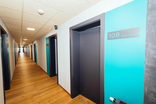 a hallway of an office building with a sign that reads line hotel at blue hotel in Kalisz