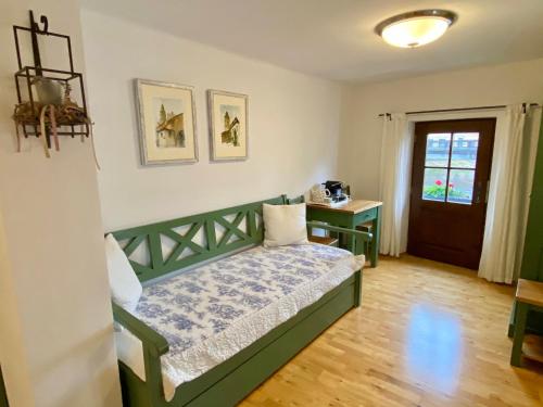 a bedroom with a bed and a table and a door at Pension Wok in Český Krumlov
