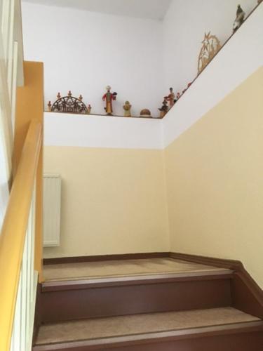 a room with a staircase with a shelf with plants at Ferienwohnung Graupner in Schwarzenberg