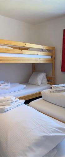 a group of bunk beds in a room at Berggasthaus Piz Calmot in Andermatt