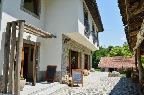 a building with a sign in front of it at Prenoćište Slapovi in Jajce