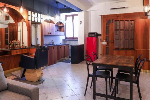 a kitchen with a table and a red refrigerator at La casa del barbiere in Loreto