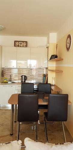 a kitchen with a table and chairs in a room at Apartment Sea Space 2 in Dobra Voda