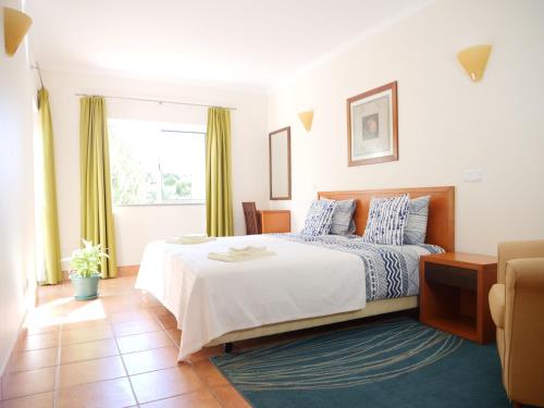 a bedroom with a large bed and a window at Large Penthouse Near Porto de Mos Beach With Magnificent Views In Lagos in Lagos
