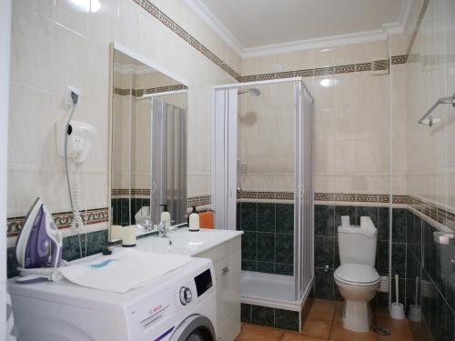 a bathroom with a toilet and a sink and a shower at Large Penthouse Near Porto de Mos Beach With Magnificent Views In Lagos in Lagos