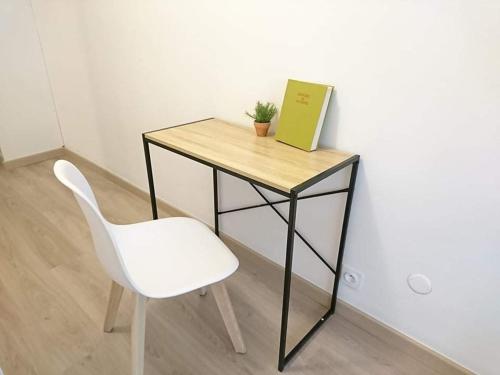 a desk with a chair and a book on it at LPA in Annecy