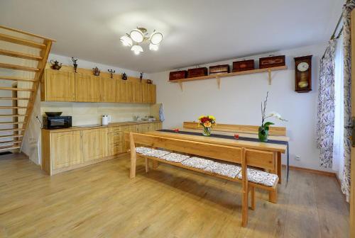 a kitchen with a wooden table in a room at Dom Krawca - pod Chojnikiem in Jelenia Góra