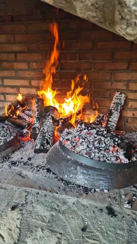 a fire in a brick oven with flames at B&B Plitvice Holiday Lodge in Plitvička Jezera