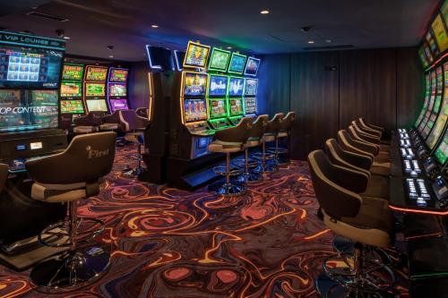 a casino with chairs and slot machines at Grand Hotel Lviv Casino & Spa in Lviv