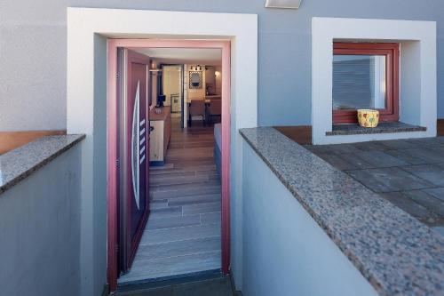a hallway of a house with a stairway leading to a kitchen at Villa Mariella in Novalja