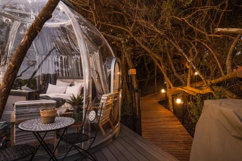 a gazebo with a bed and a table and chairs at The Dome - Misty Mountain Reserve in Thornham