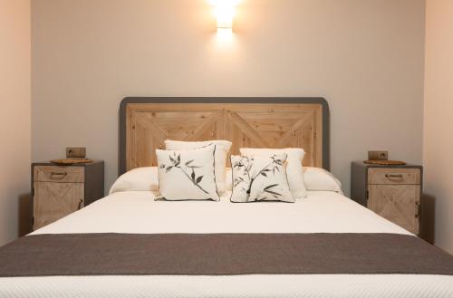 a bedroom with a white bed with two night stands at Casa Gabriela Hotel in Jiménez de Jamuz
