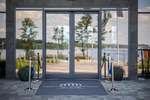 an entrance to a building with a glass door at Hotel Marina Club in Olsztyn