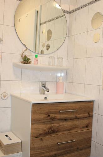 a bathroom with a sink and a mirror at FeWo an der Mühle in Bad Bentheim
