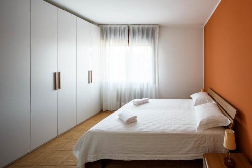 a bedroom with a white bed and a window at Appartamento Calmo 3SX in Venice-Lido