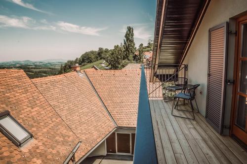 a balcony with a view of the roofs of a house at Weinhotel Maitz Wolfgang in Ratsch an der Weinstraße