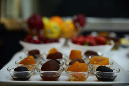 a table topped with small cups of chocolate and other desserts at Hotel Comfort in Tirana