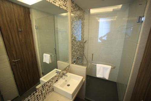 a bathroom with a sink and a mirror at The Byke Delotel in Mumbai
