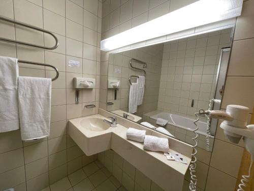 a bathroom with a sink and a mirror at Hotel Berghof in Sonnenalpe Nassfeld