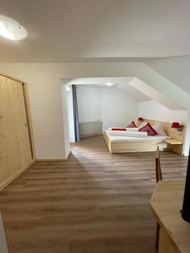 an attic room with two beds and a hallway at Hotel Berghof in Sonnenalpe Nassfeld