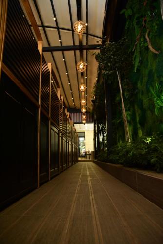 an empty hallway with plants in a building at Hotel Comfort in Tirana
