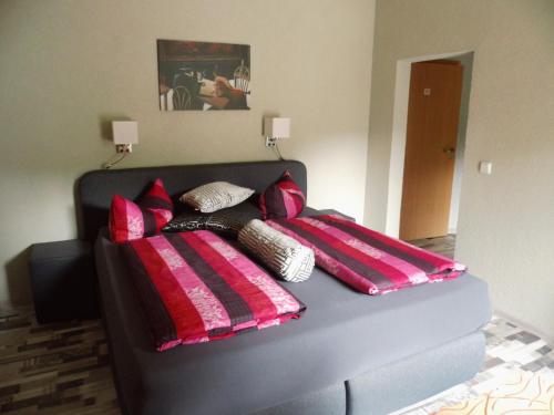a couch with pillows on it in a room at Hotel Restaurant Zum Valwiger Herrenberg in Valwig