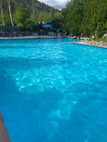 a large swimming pool with blue water at Palacete Plaza Mayor in El Burgo de Osma